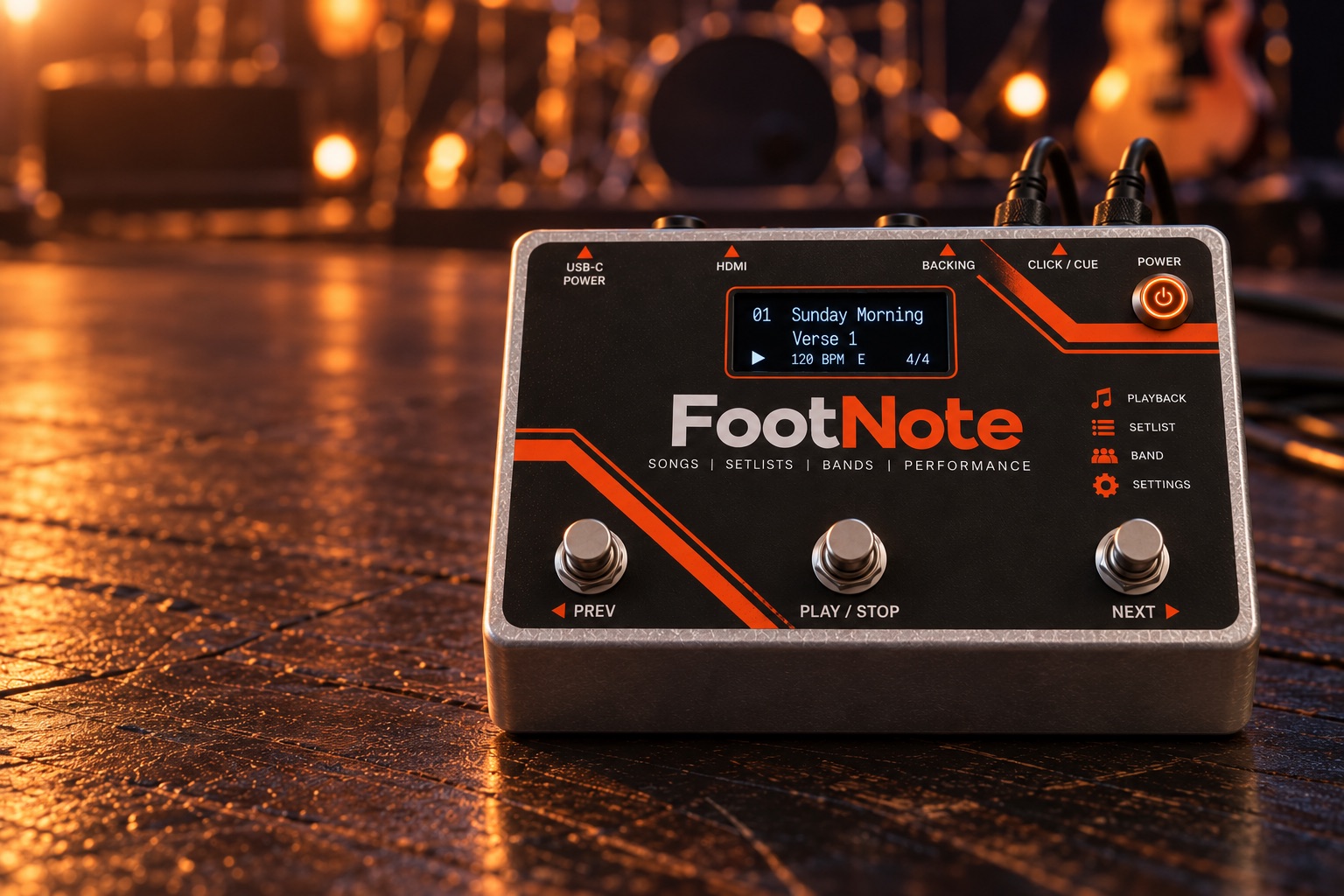 The FootNote performance pedal on a stage floor, with three footswitches and a status display